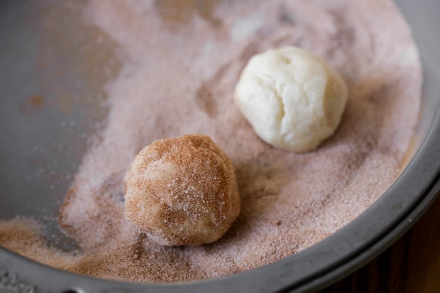 Snickerdoodle cookie balls rolled in cinnamon and sugar