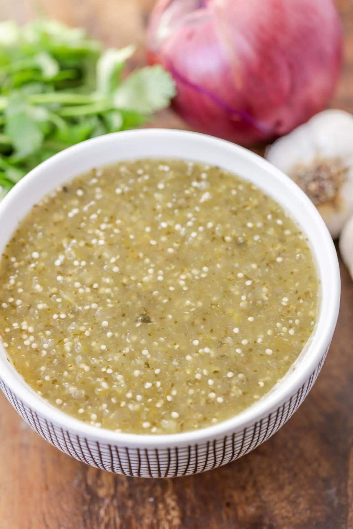 Tomatillo salsa stored in a bowl close up.