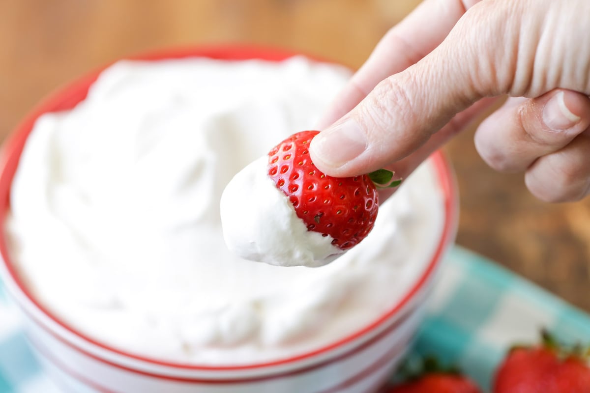 Whipped cream recipe in bowl with strawberry