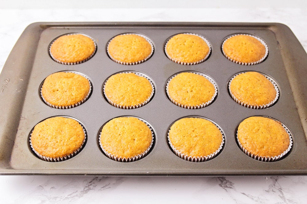 Carrot cake cupcakes cooked in a muffin tin.