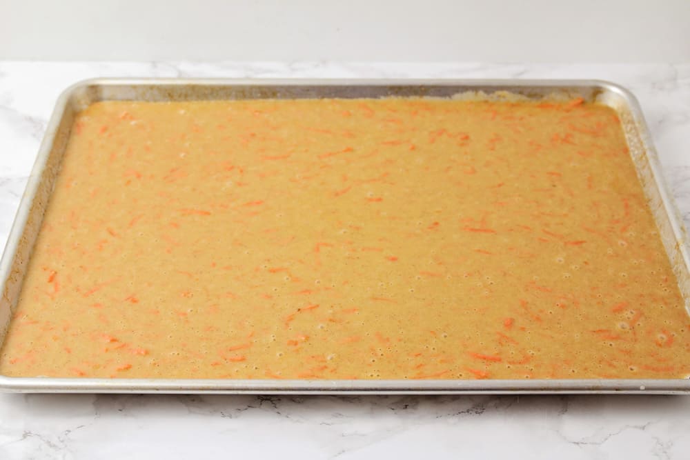 Carrot cake batter poured into a jelly roll pan.