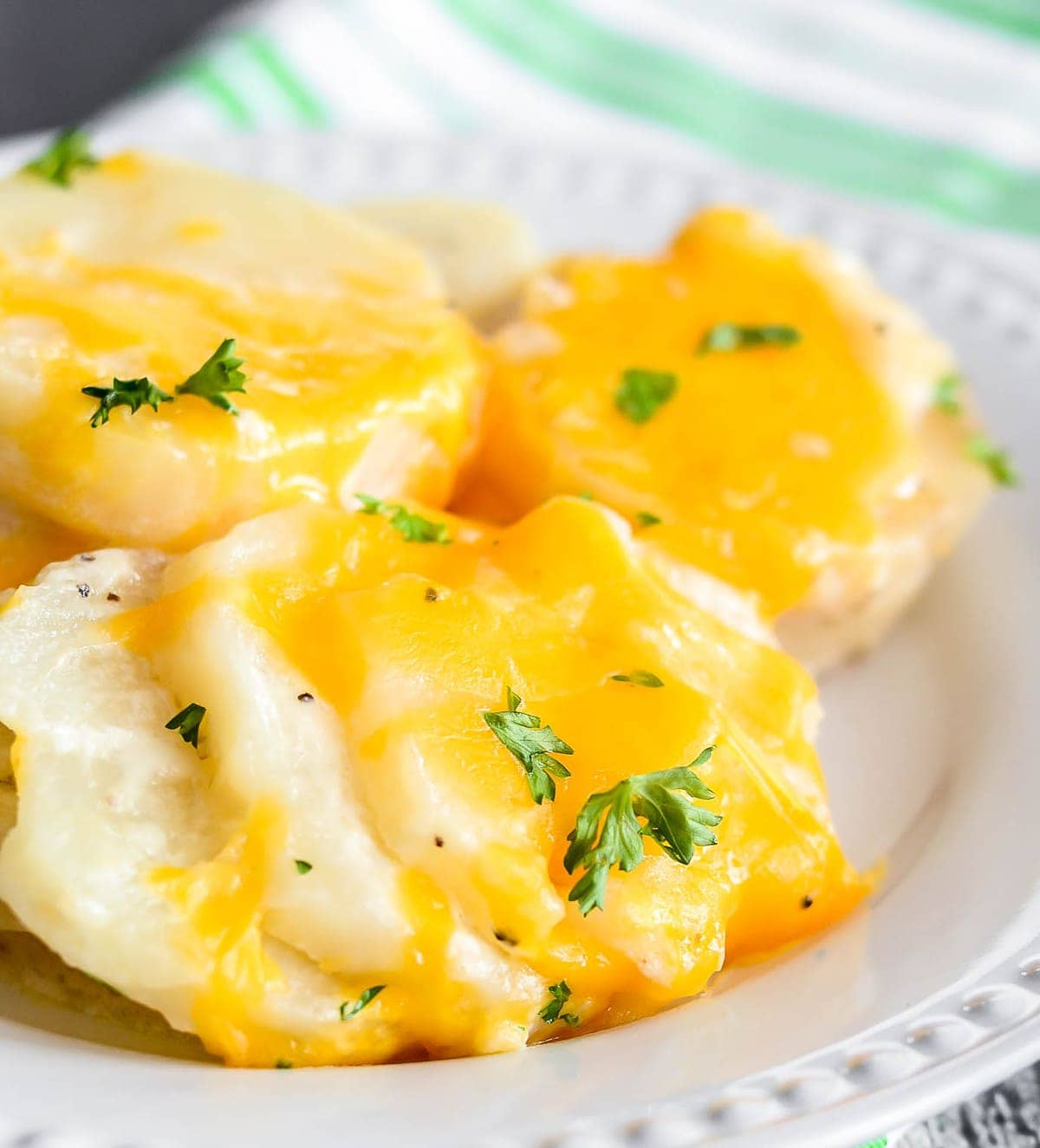 Crockpot side dishes - crockpot scalloped potatoes covered with cheese.