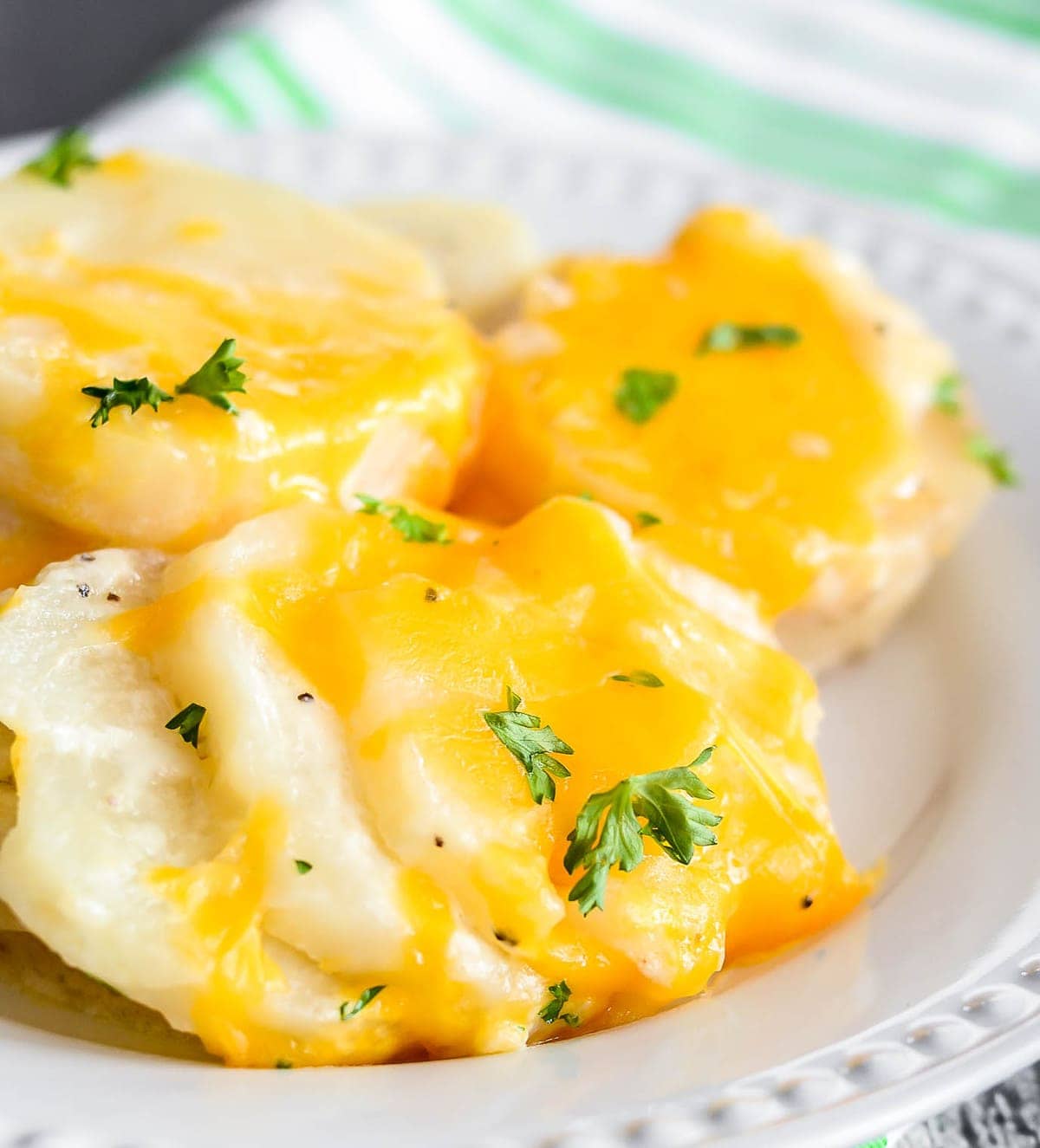 Cheesy crock pot scalloped potatoes served on plate.