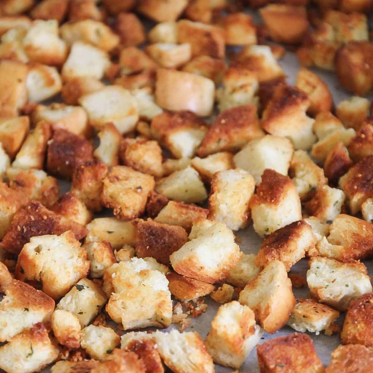 Homemade croutons baked on a cookie sheet.