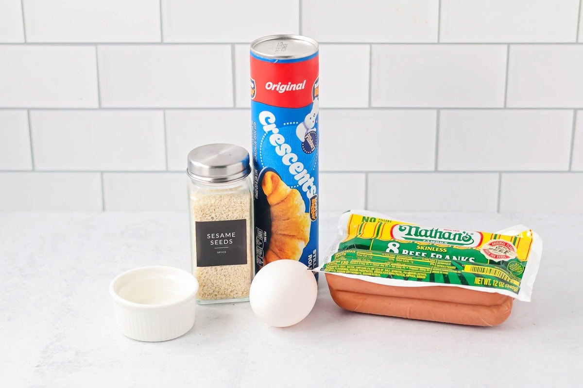 Quick and easy pigs in a blanket bring that nostalgic, kid-approved dinner to the table in just 20 minutes, for a guaranteed family favorite! Pigs in a Blanket ingredients on counter.