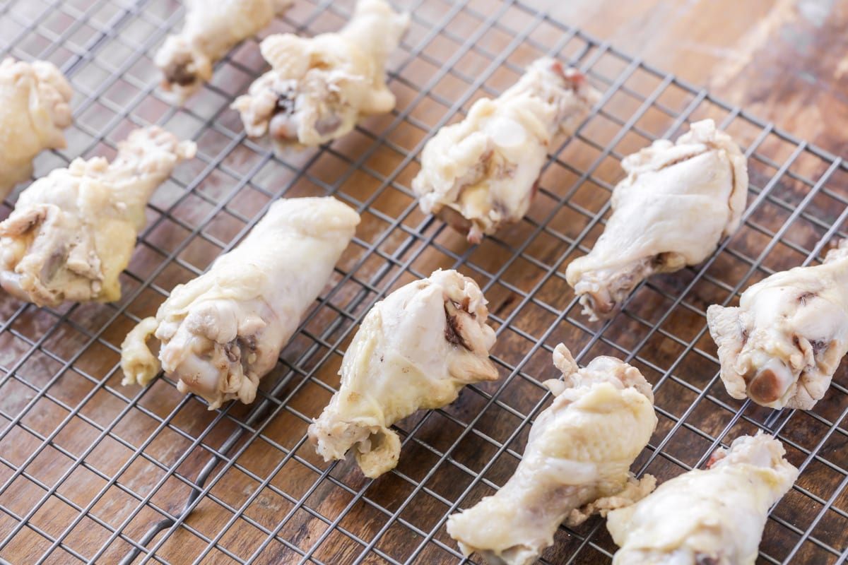 raw chicken wings on a wire rack for baked chicken wings