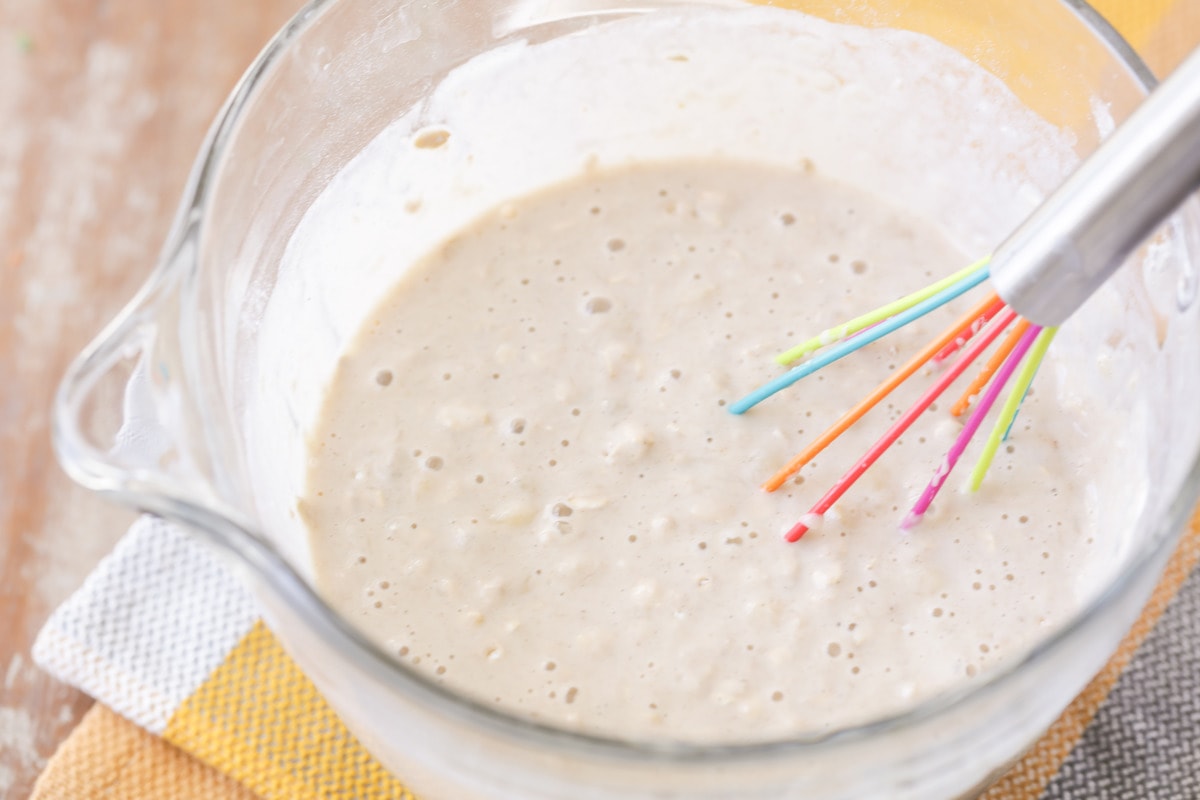 Banana oatmeal pancake batter being mixed with a whisk