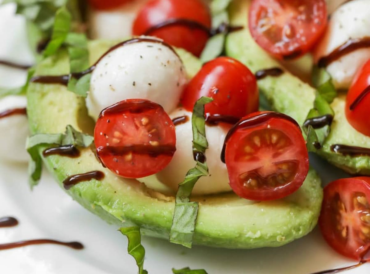 Italian Christmas Dinner ideas - a close up of a plate filled with caprese stuffed avocados.