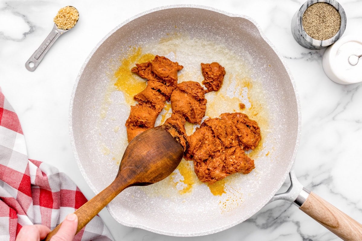 Chorizo being cooked in skillet.