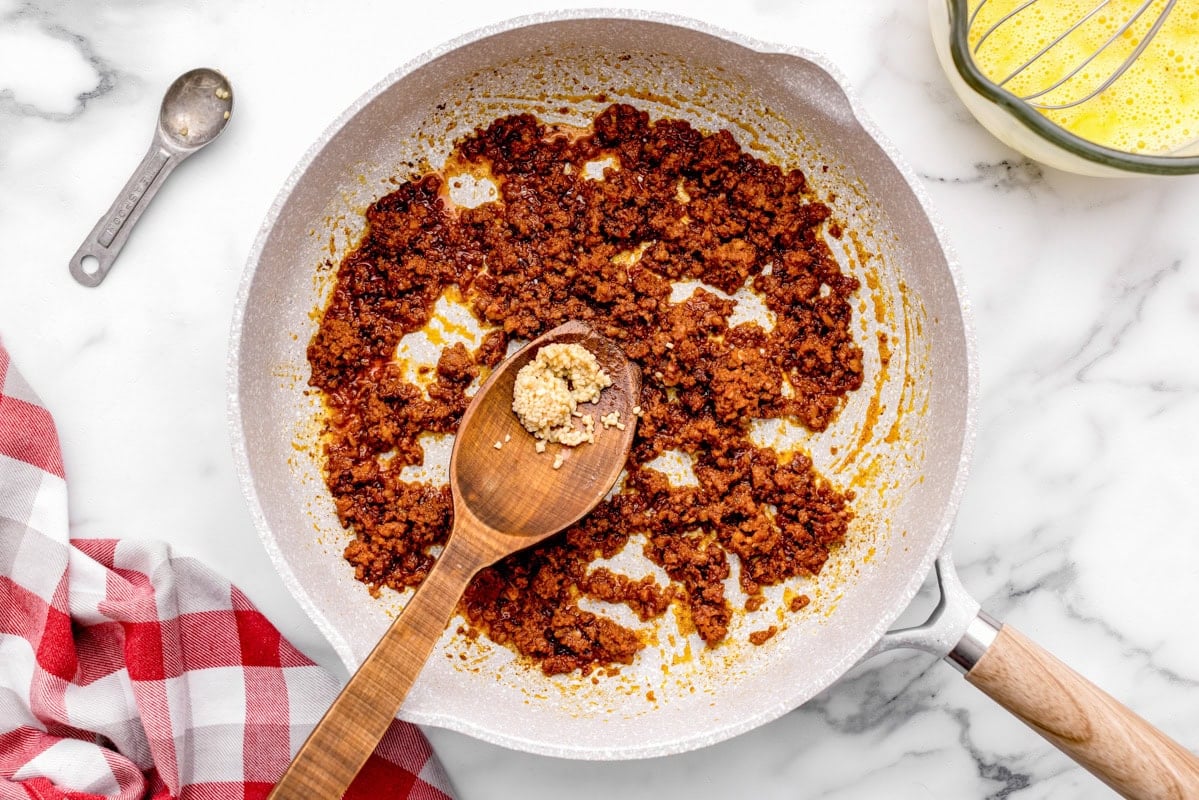 Chorizo sausage cooked in skillet.