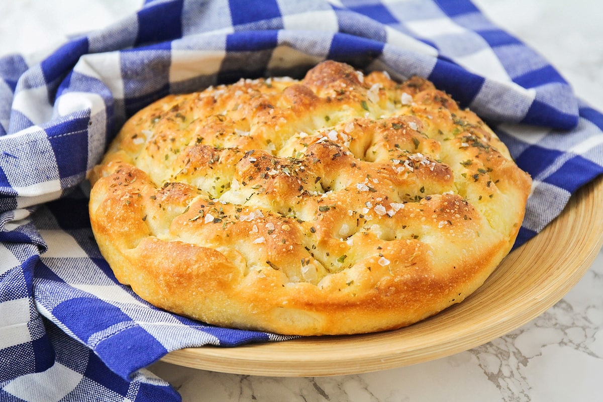 Focaccia bread topped with seasoning.