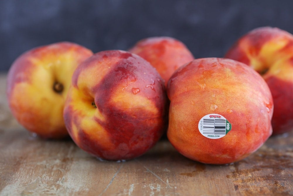 Prima peaches washed on a wooden table.