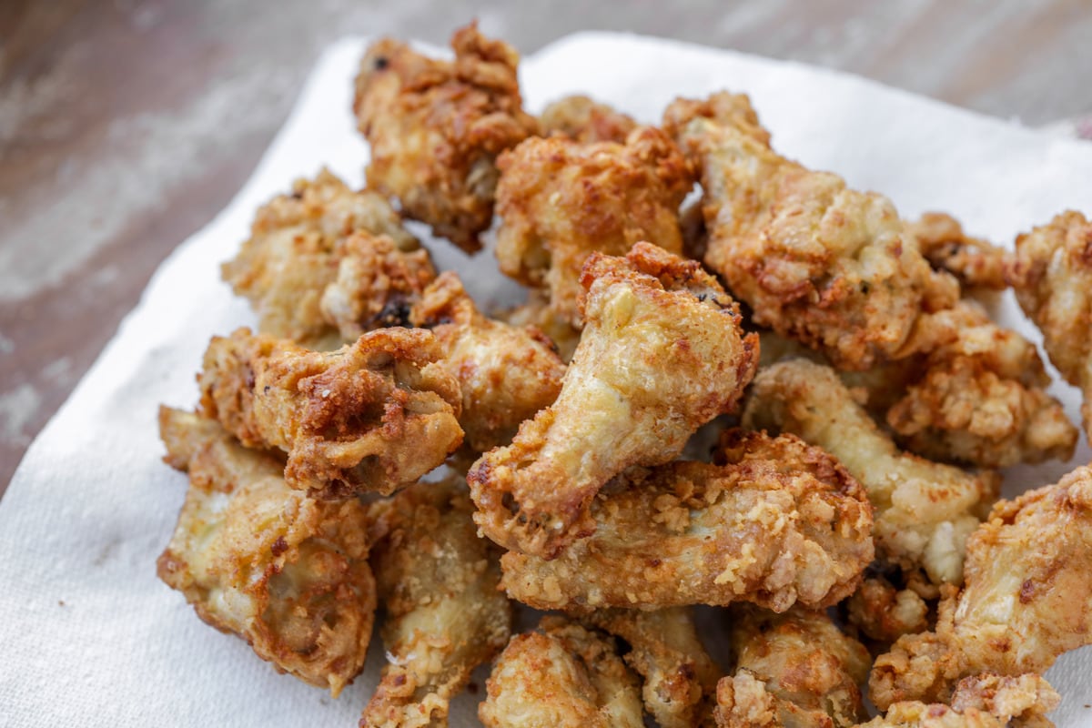 Chicken buffalo wings on a paper towel ready for coating with sauce. 