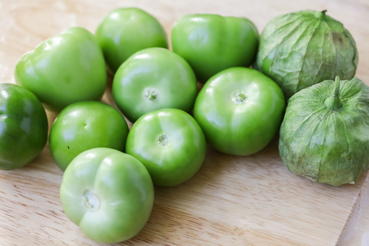 Tomatillos on cutting board.