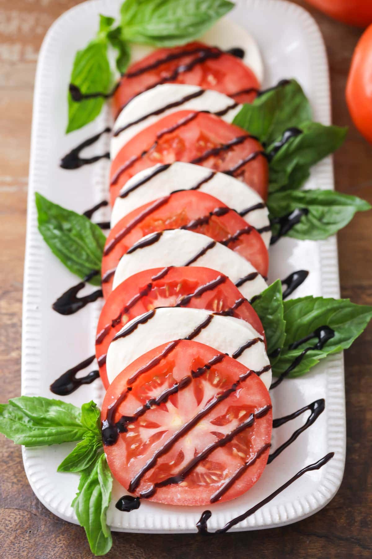 Tomato basil mozzarella salad with balsamic glaze drizzle.