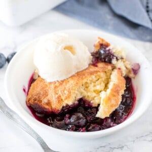 Delicious blueberry cobbler with a fluffy biscuit top and tons of juice blueberries served with a scoop of vanilla ice cream.