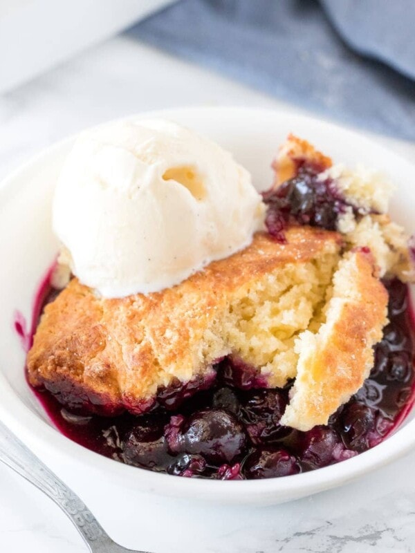 Delicious blueberry cobbler with a fluffy biscuit top and tons of juice blueberries served with a scoop of vanilla ice cream.