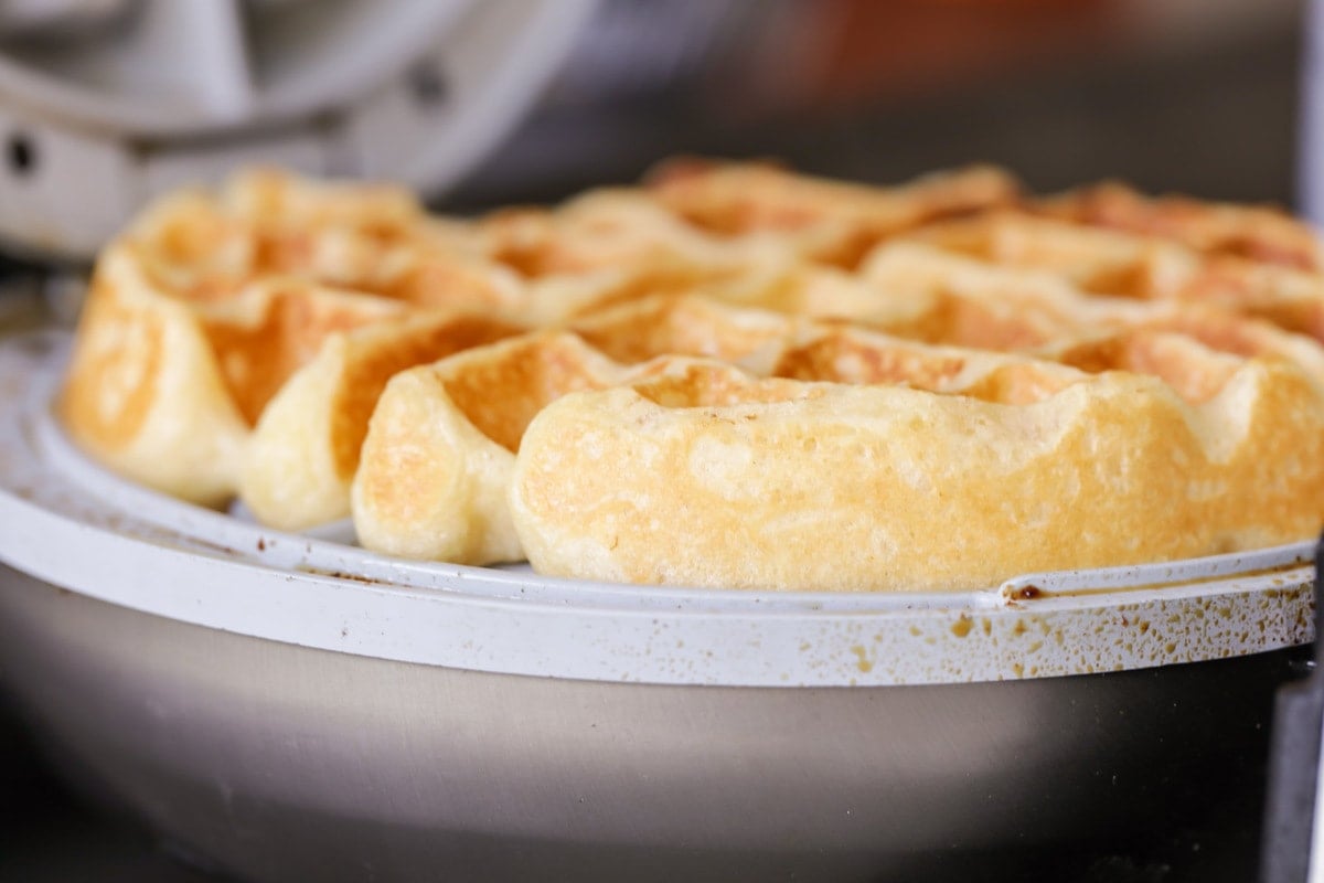 Closeup of a fluffy buttermilk waffle inside the waffle iron.