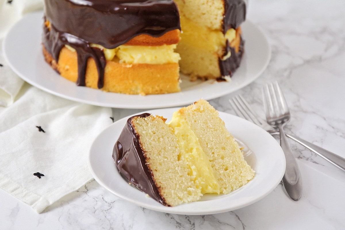 Boston Cream Pie slice on white plate.