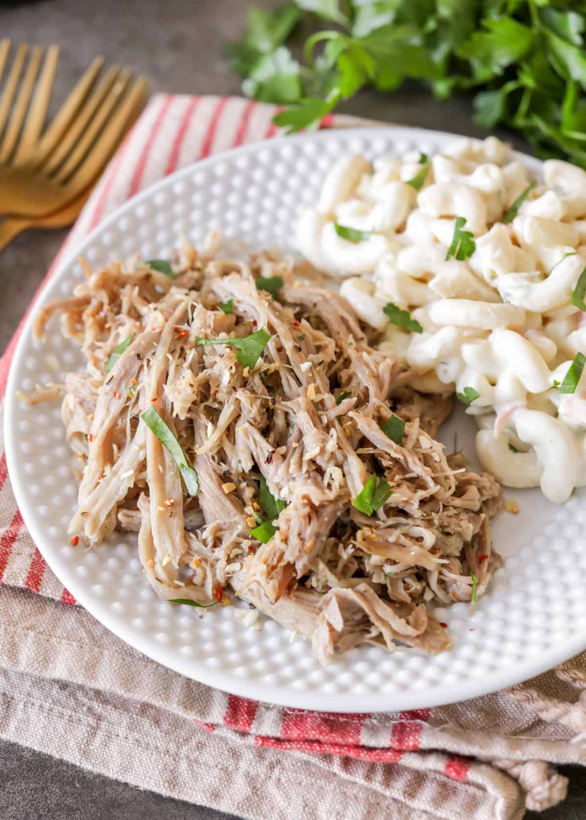 Slow Cooker Kalua Pork served on plate with macaroni salad.