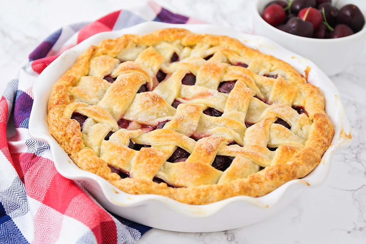 Cherry pie in a white pie pan.