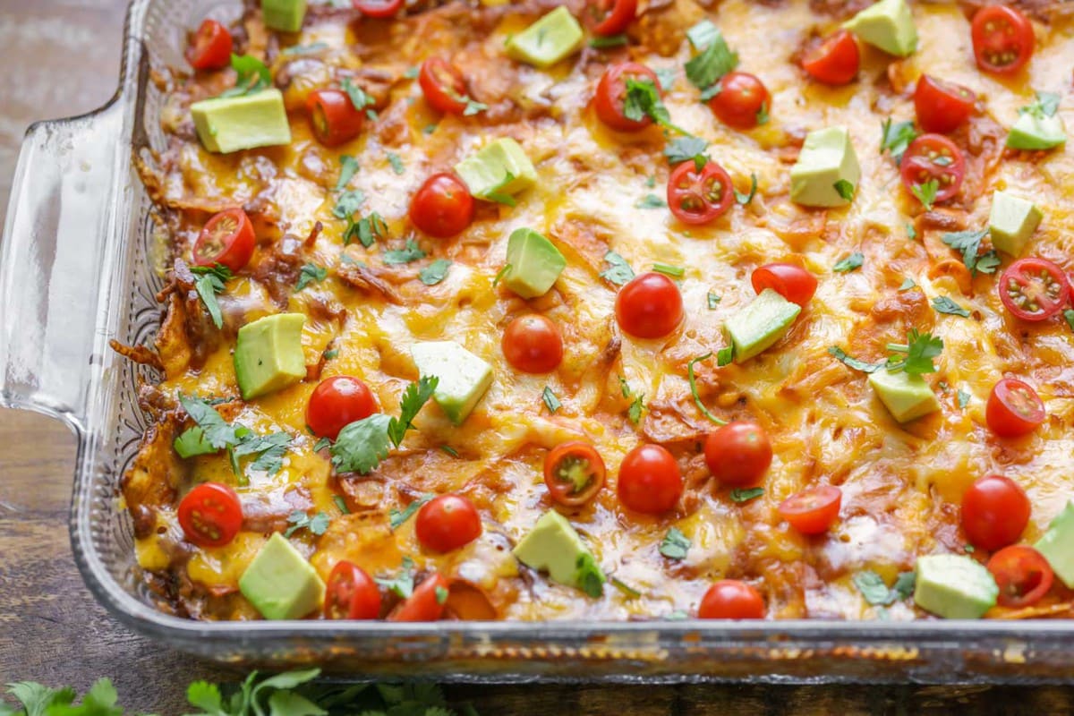 Fall dinner ideas - Dorito casserole topped with avocado and tomatoes.