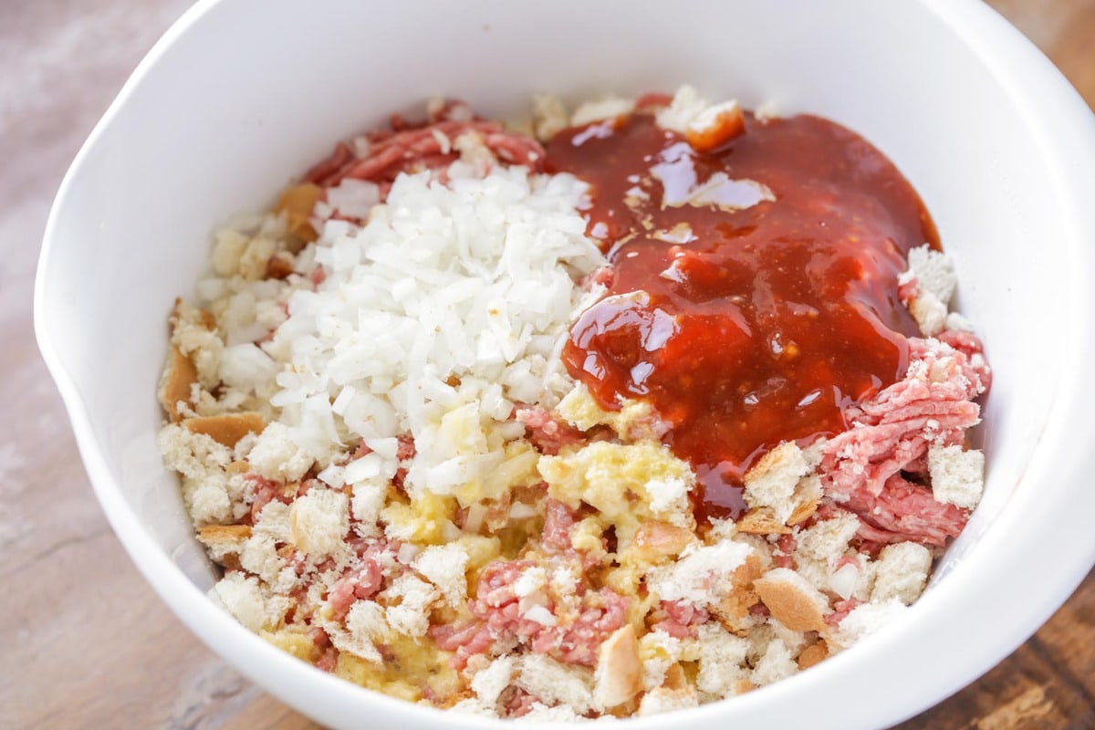 Ingredients for classic easy meatloaf recipe in a mixing bowl.