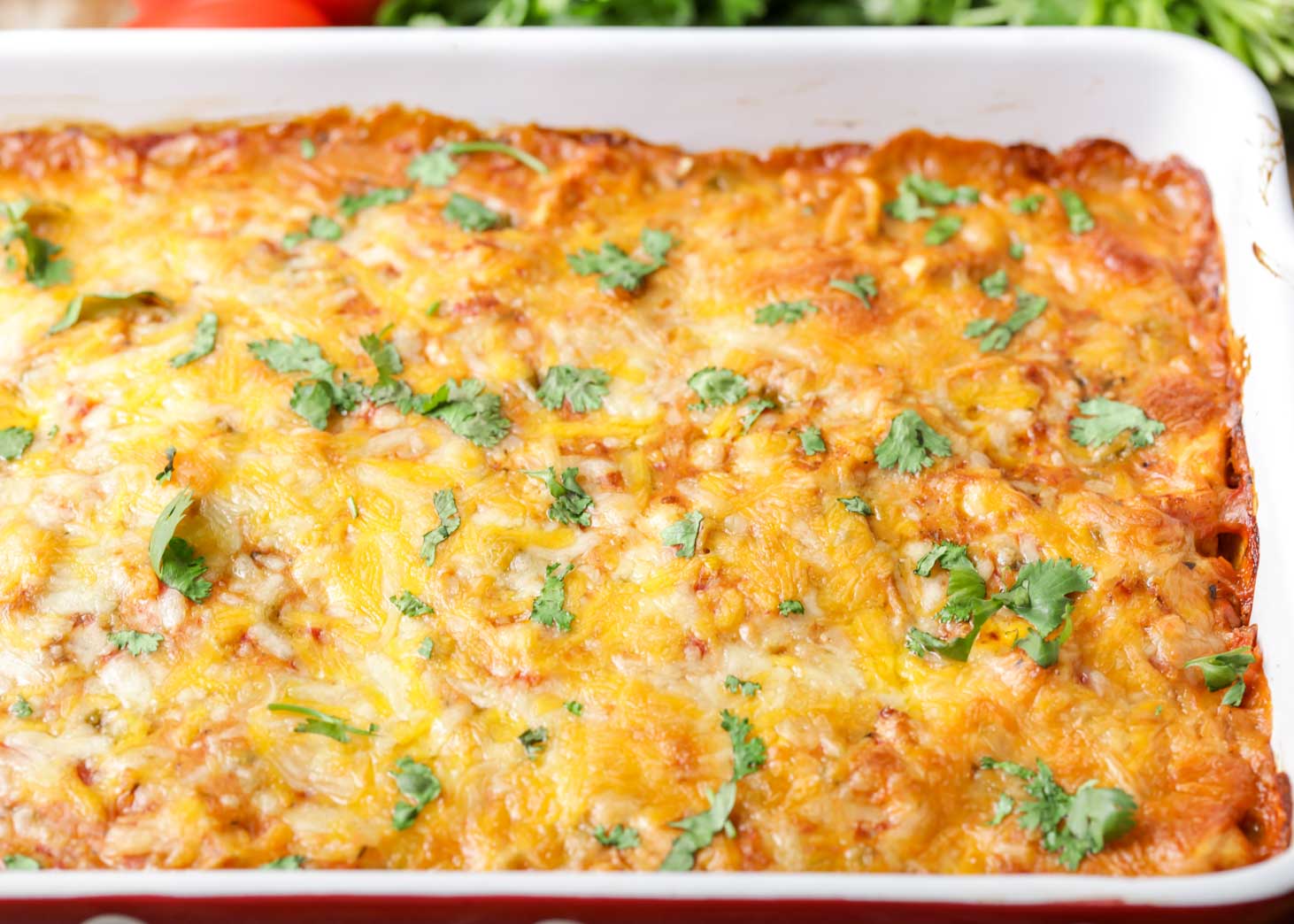 Mexican casserole topped with cilantro in a baking dish