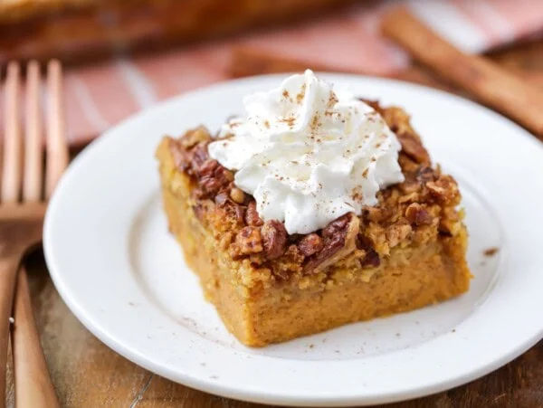 Slice of pumpkin crunch cake on a white plate.