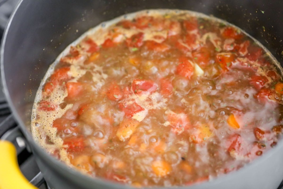 Homemade vegetable soup cooking in a pot on the stove
