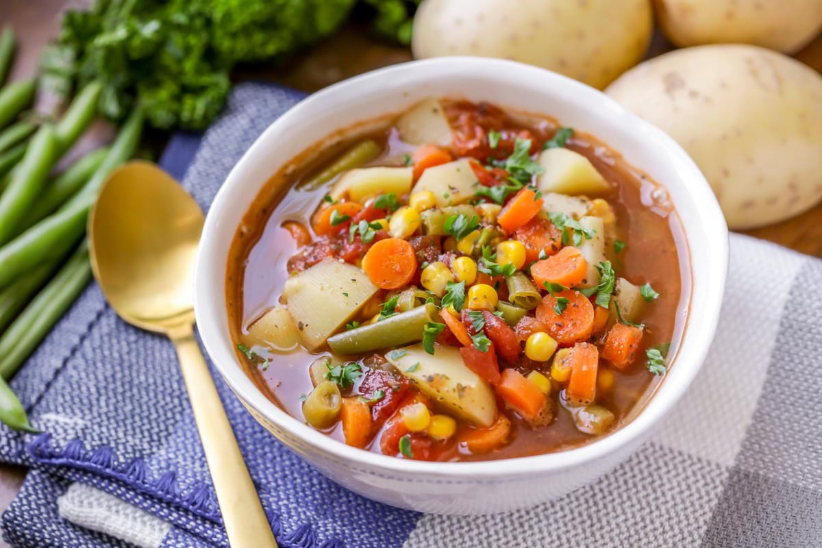 Homemade vegetable soup served in a white bowl.