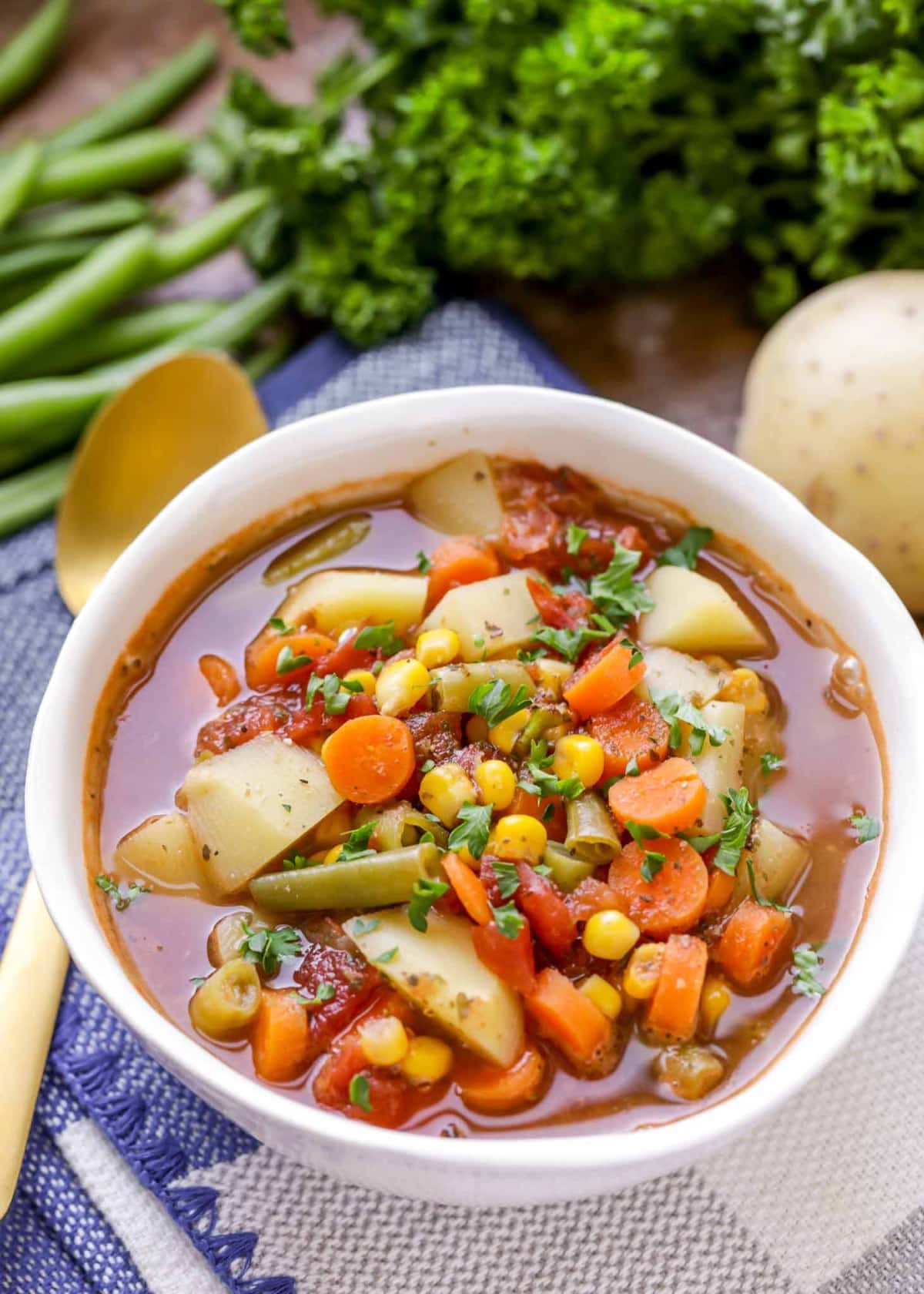 Vegetable soup with corn, carrots, green beans, potatoes, and tomatoes