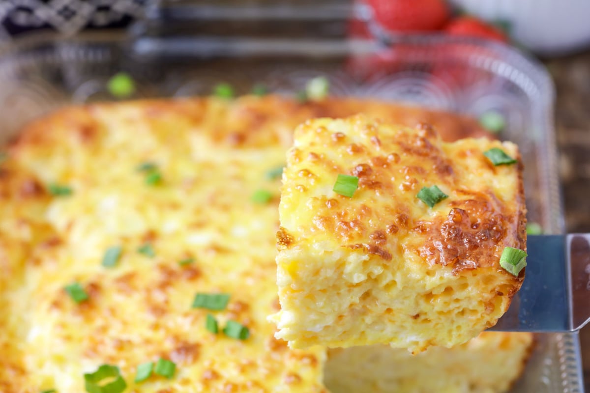 Baked Eggs in a casserole dish being served with a spatula.