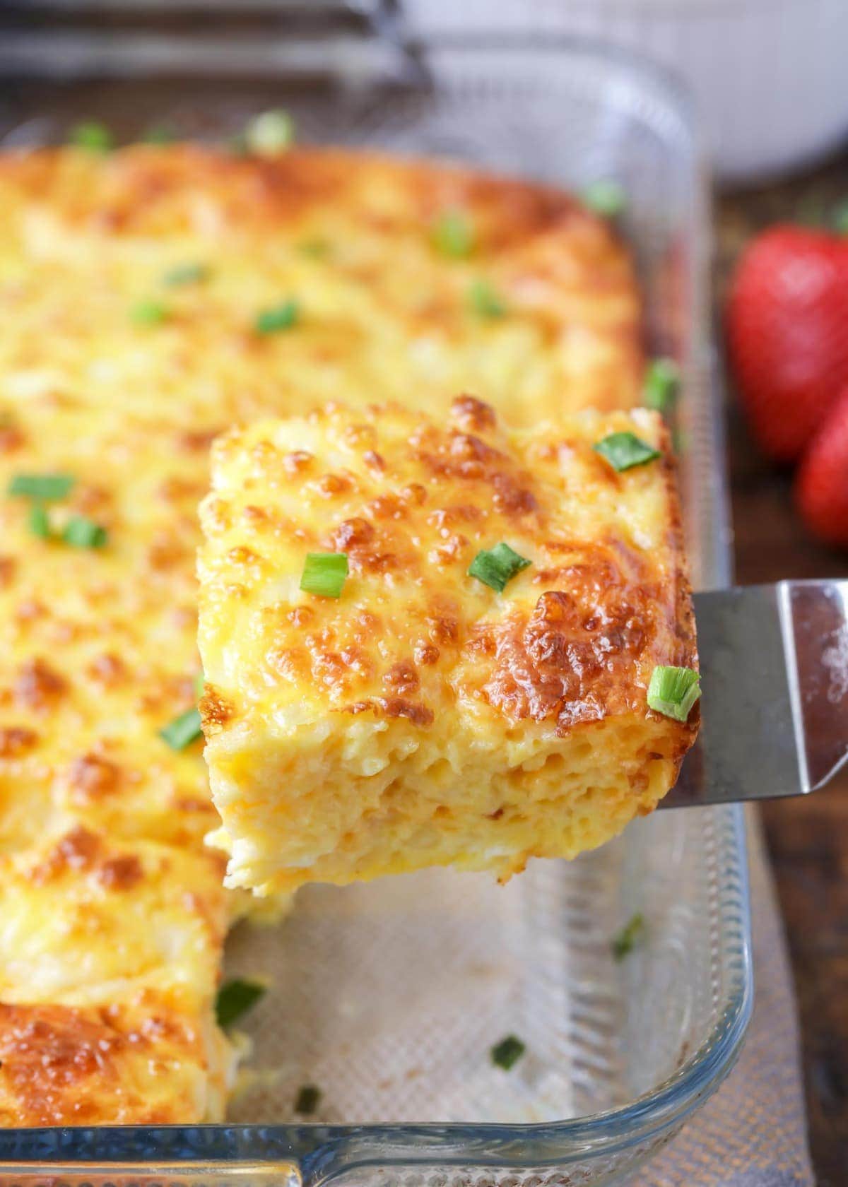 A slice of Baked egg casserole on a spatula.