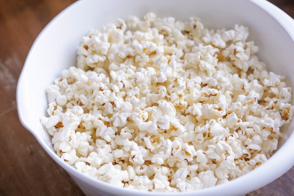 Plain popcorn popped in a white bowl.