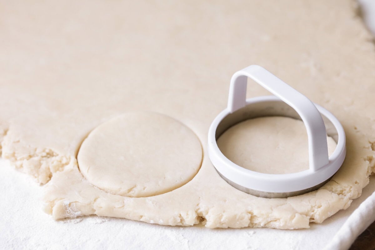Cutting biscuit rounds from rolled dough.