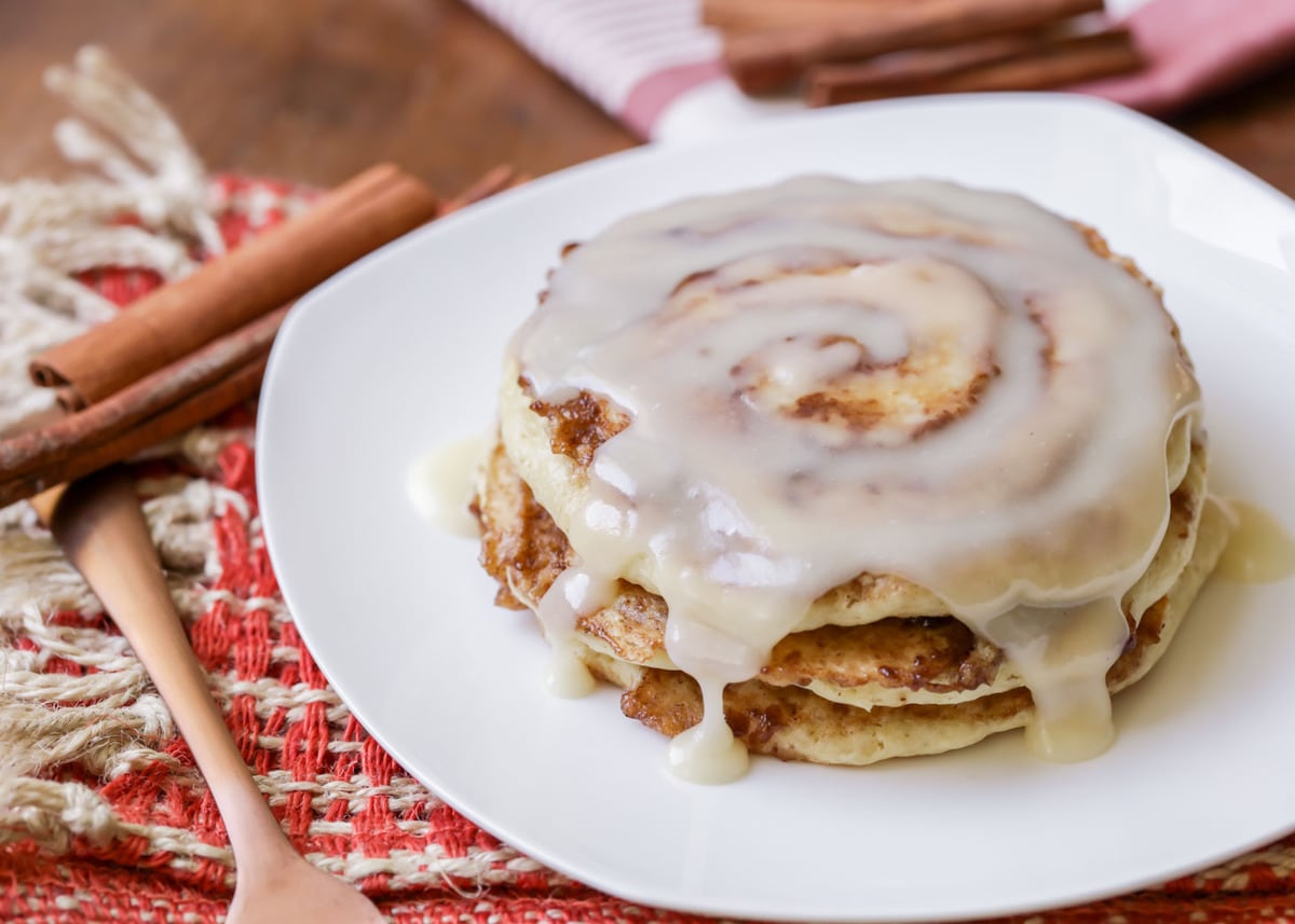 Easy breakfast recipe - cinnamon roll pancakes drizzled with icing.