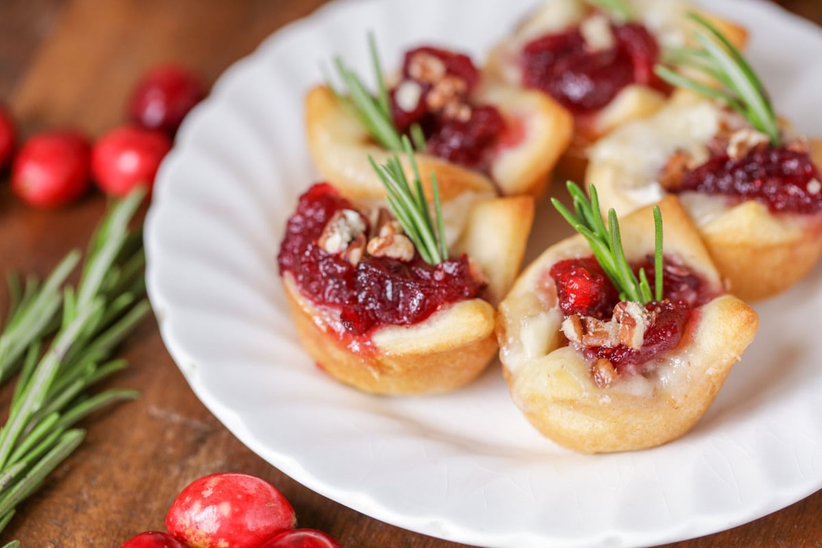 Cranberry brie bites on a white plate.