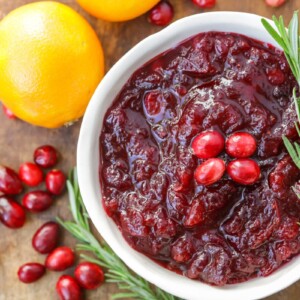 A bowl of fresh cranberry sauce with fresh herbs.
