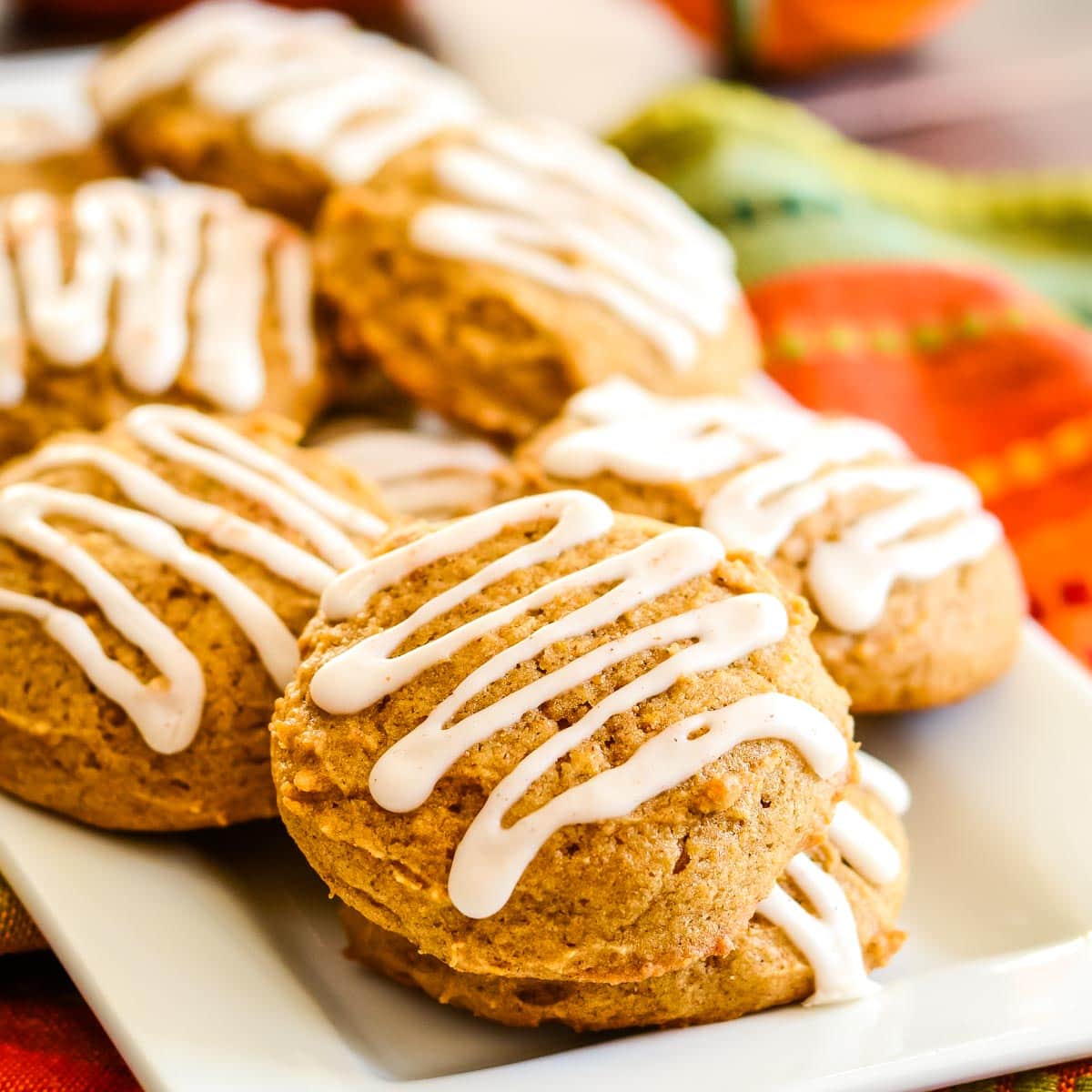 Iced pumpkin cookies on plate