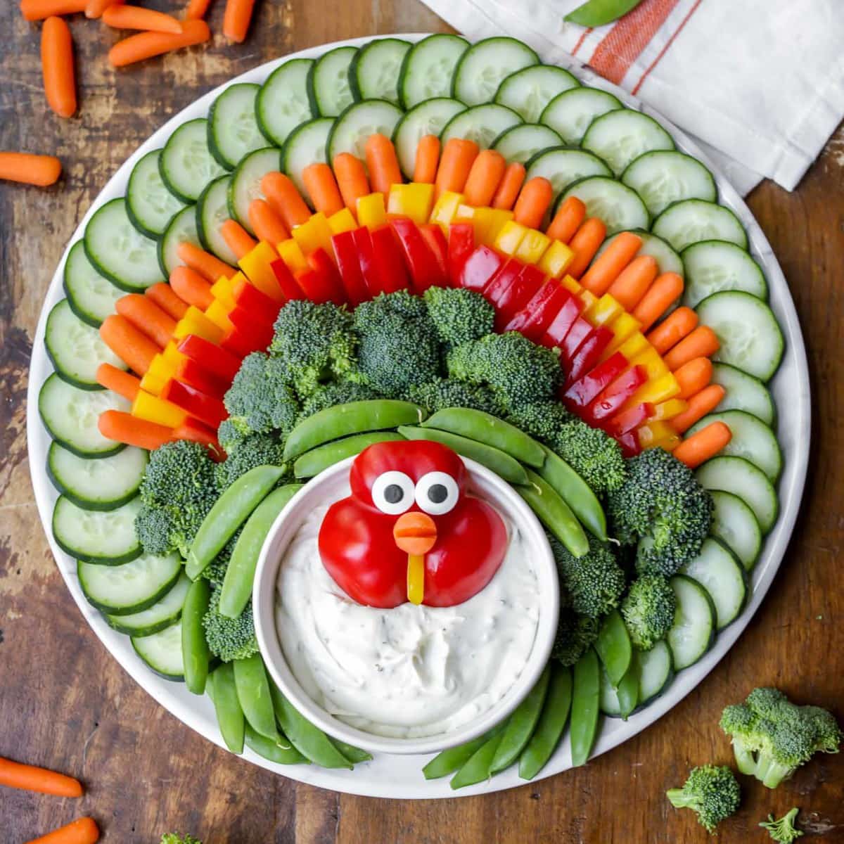 Turkey veggie tray with cucumbers, carrots, peppers, broccoli, and peas.