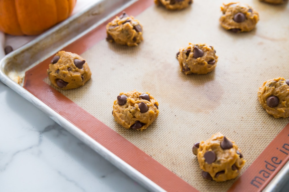 Pumpkin chocolate chip cookies scooped on baking sheet