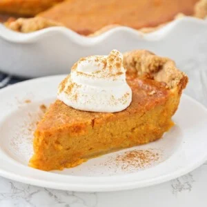 A slice of sweet potato pie on a white plate.
