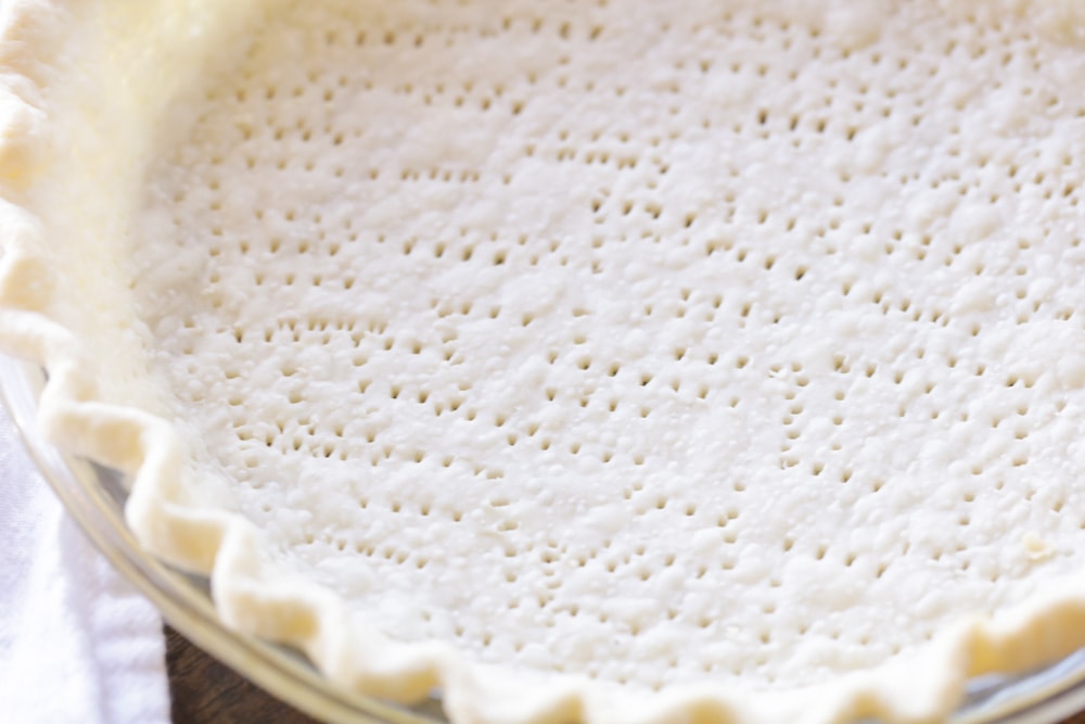 Pie crust with fork holes poked in it.