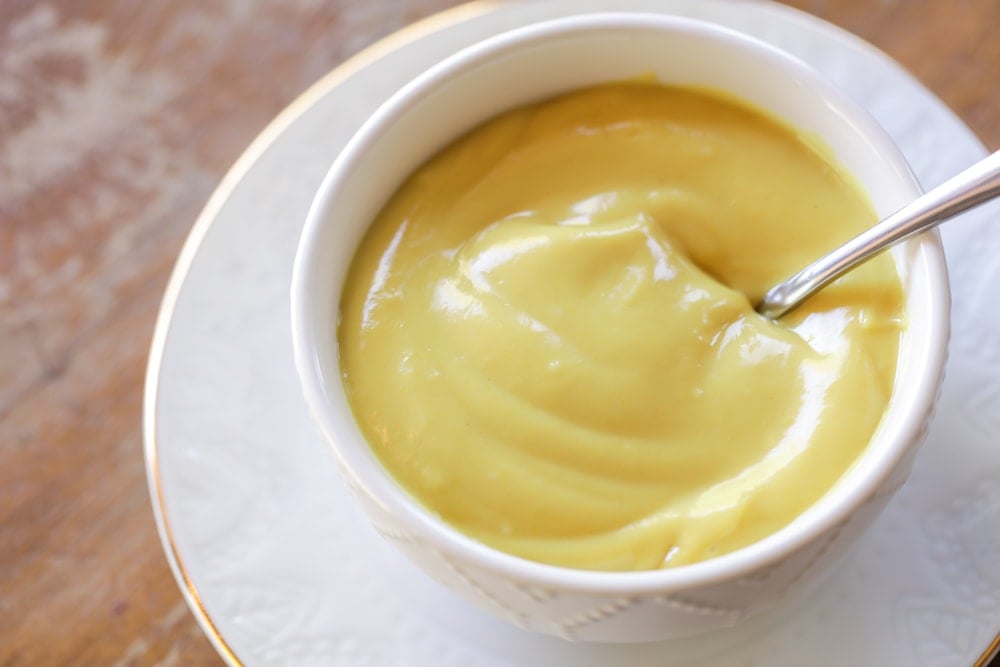 A white bowl filled with homemade honey mustard sauce.