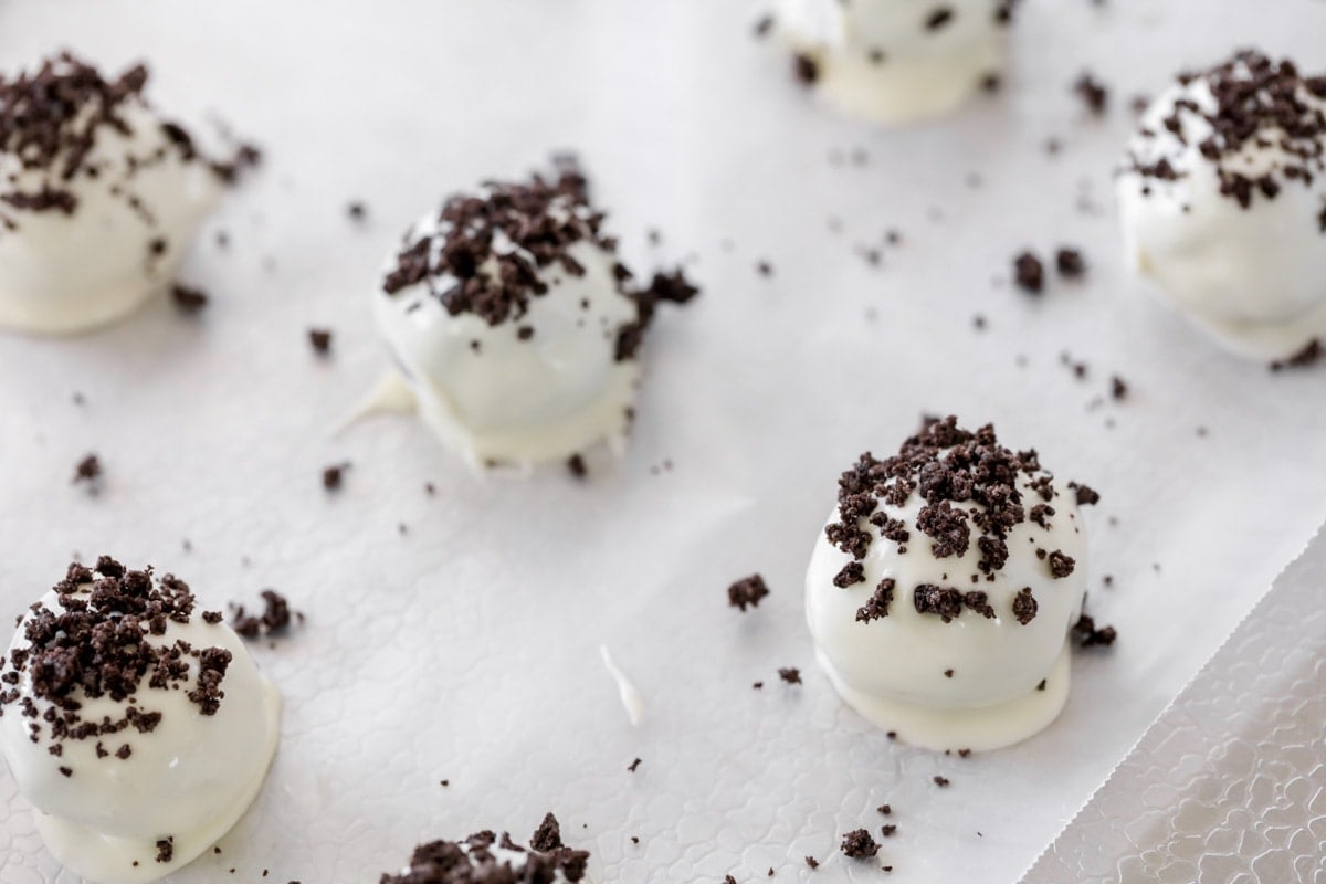 Oreo balls dipped in white melting candy and topped with crushed oreo.