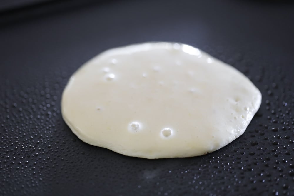 close up of protein powder pancakes cooking on a skillet