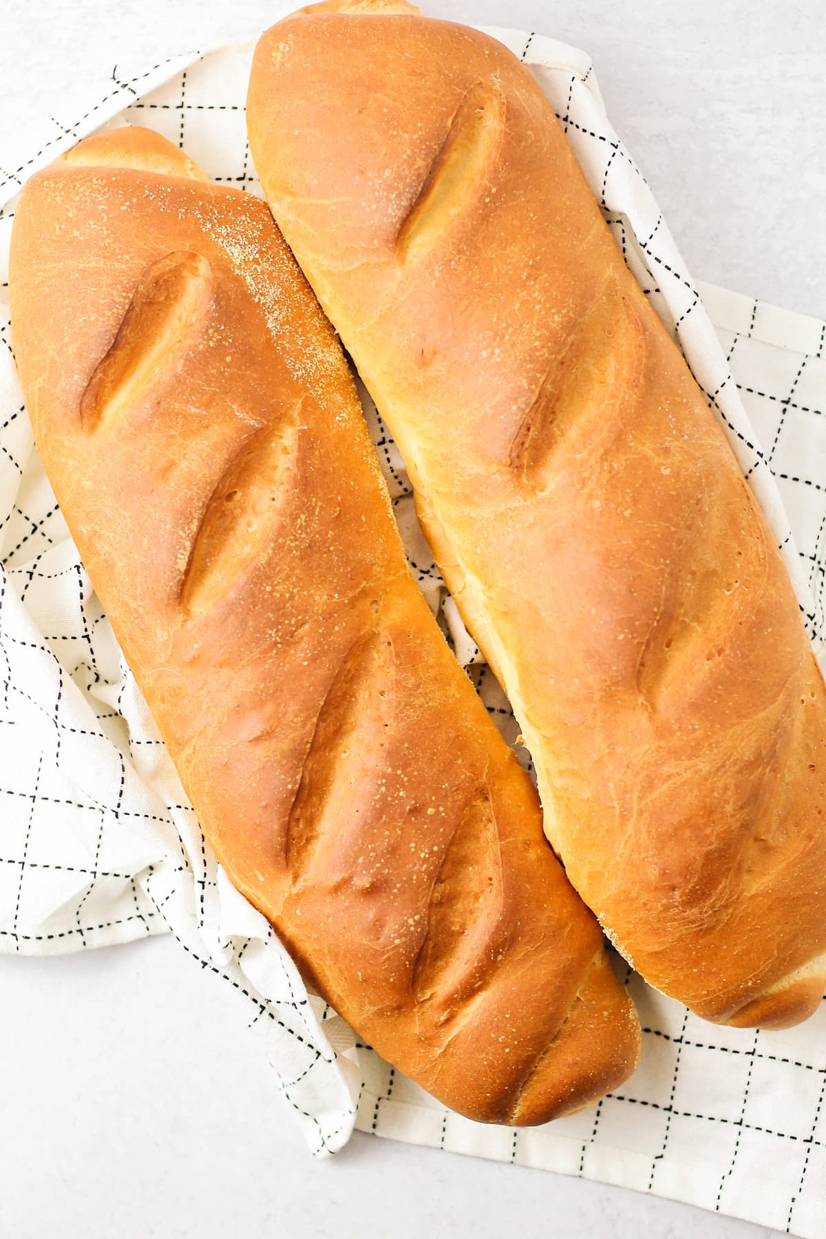 2 loaves of our Italian bread recipe on dishcloth.