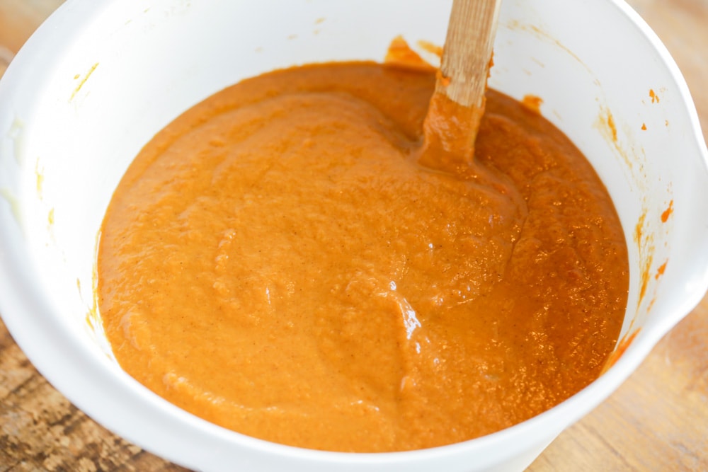 Pumpkin cobbler ingredients mixed in a white bowl.