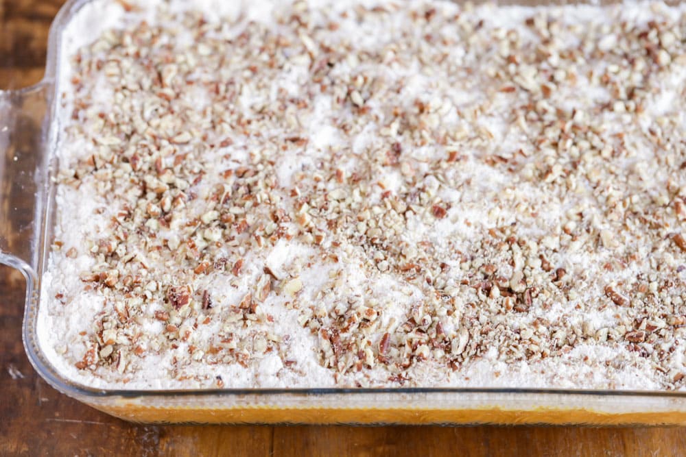 Pumpkin cobbler recipe layered in a baking dish ready for baking.